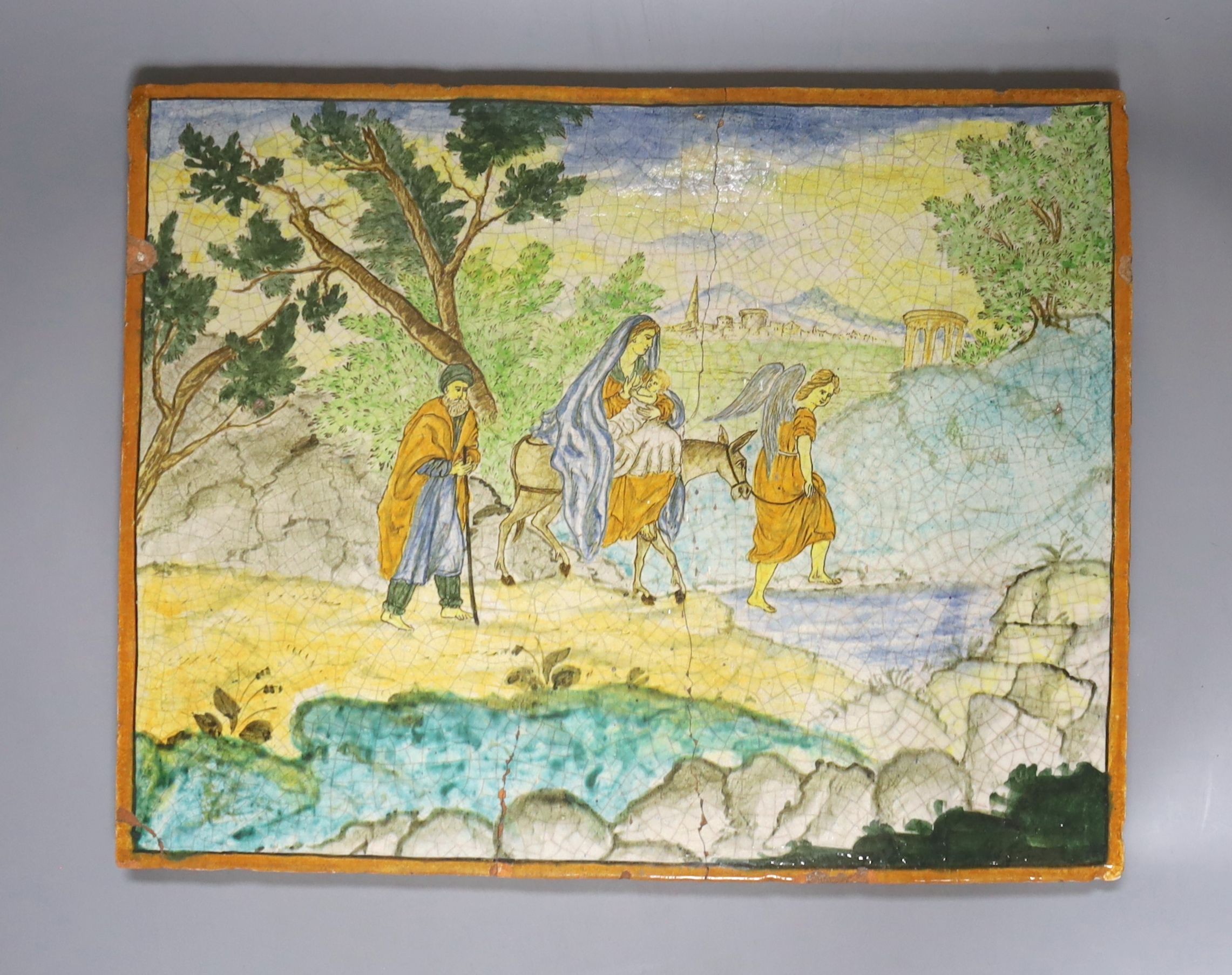 A 19th century Italian maiolica plaque decorated with the 'Return from Egypt', 27 x 35cm (a.f.)